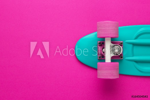 Picture of plastic mini cruiser board on deep pink with background with copy space